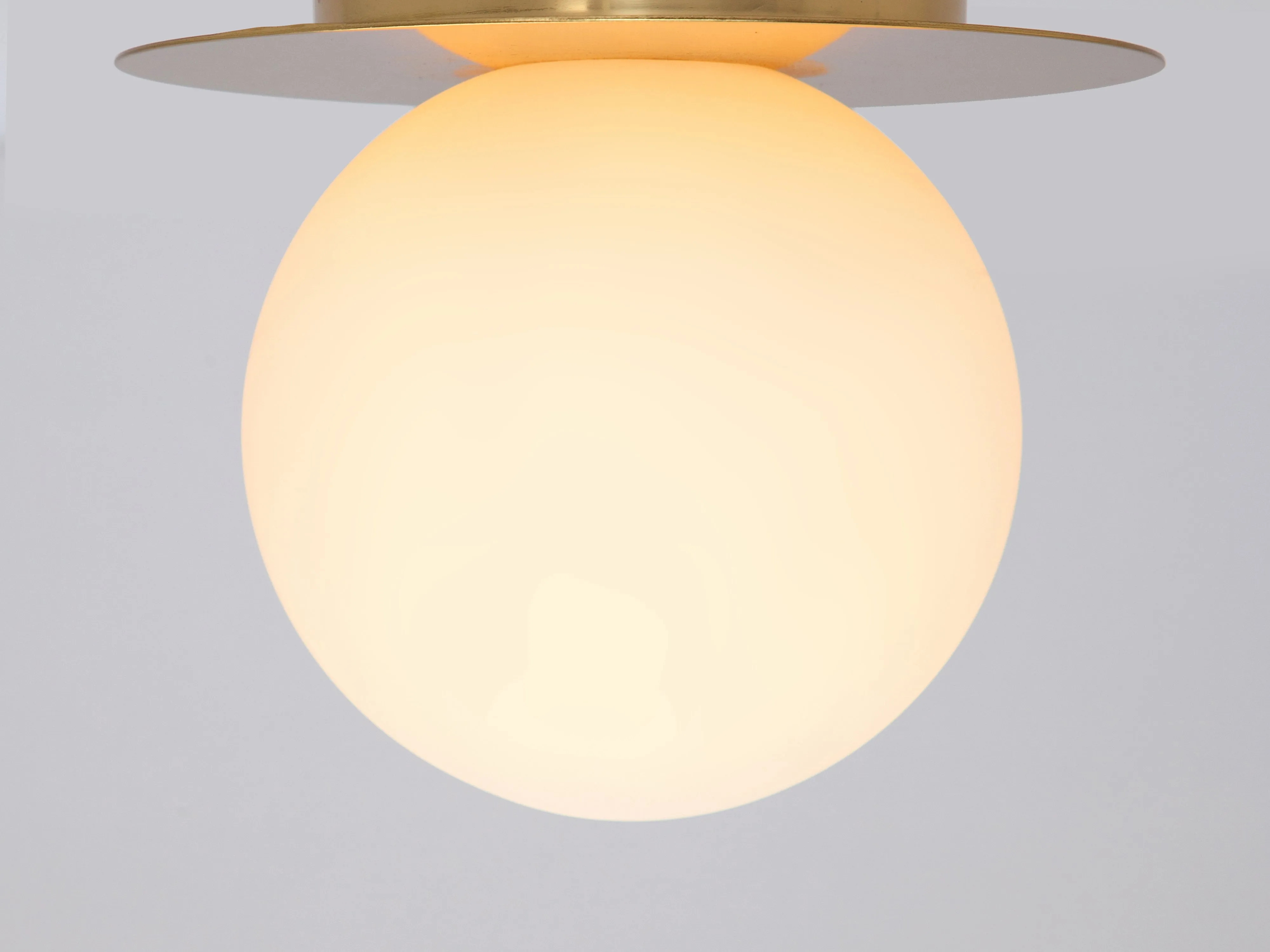 Brass opal disk wall light