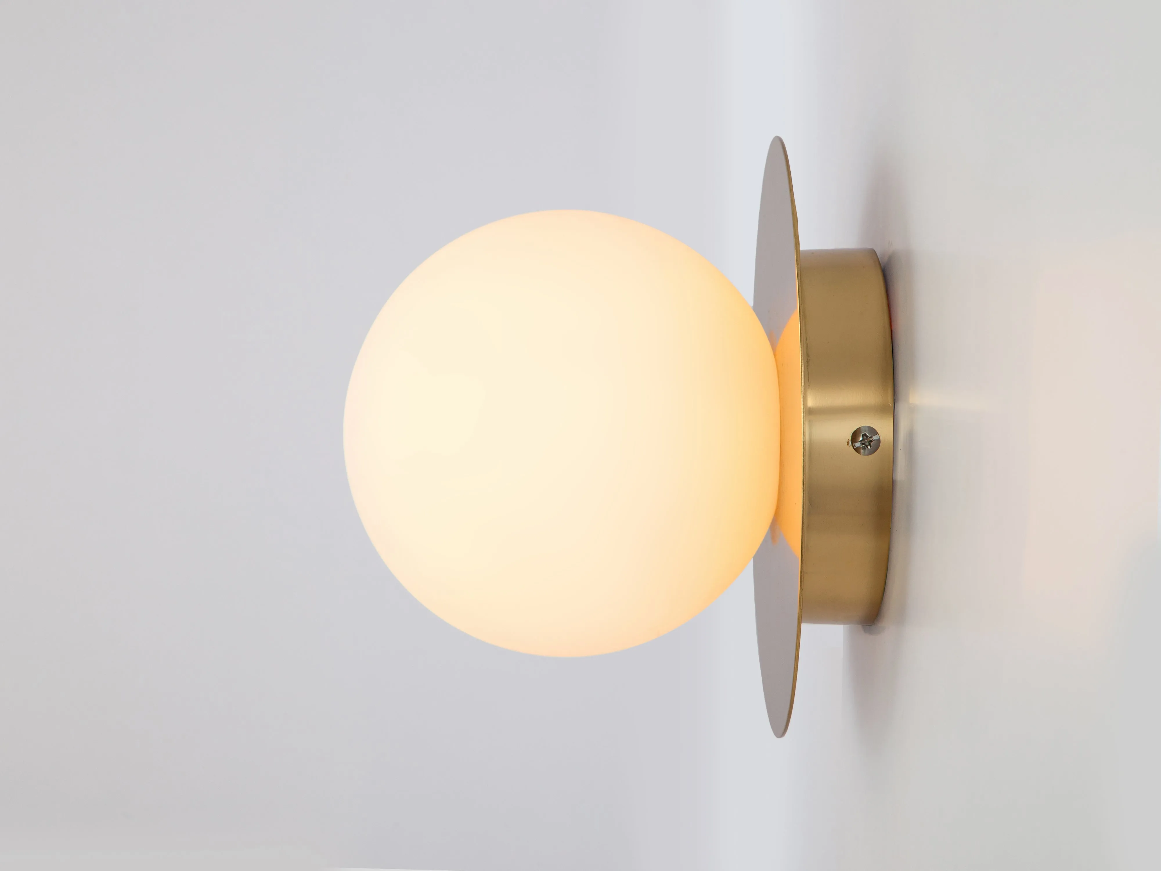 Brass opal disk wall light
